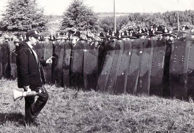 Miners leader Arthur Scargill addresses police with riot shields outside the Orgreave Coking Plant in 1984