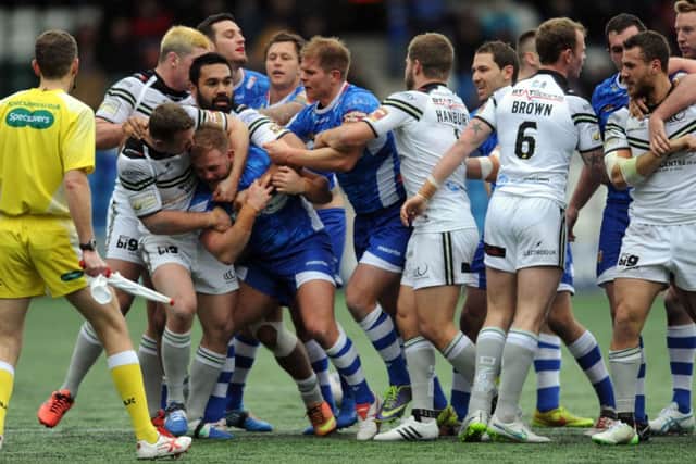 Crushed: Wakefields Matt Ryan runs into the challenge of Widnes Vikings Chris Dean of Widnes. Inset, tempers flare between both sets of players. Picture: Steve Riding