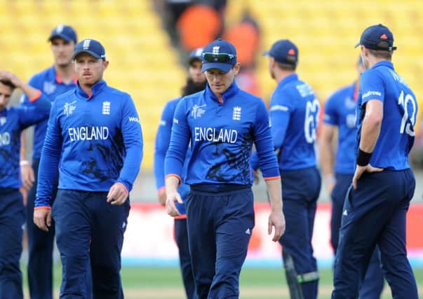DOWNED, BUT NOT OUT: Englands captain Eoin Morgan leads his player's from the field after they lost to Sri Lanka by nine wickets. Picture: AP/Ross Setford.