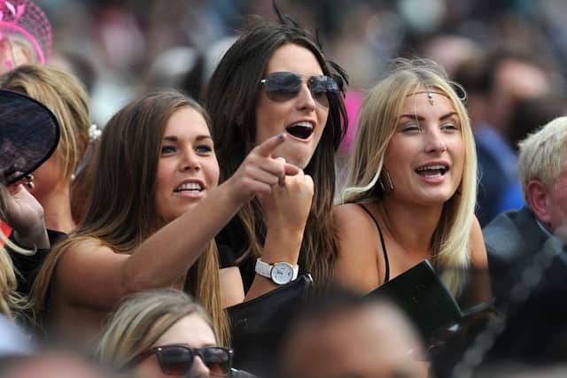 Racegoers cheer on the action during Day One of the 2014 Welcome To Yorkshire Ebor Festival