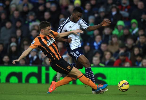 Alex Bruce, seen tackling West Bromwich Albions Brown Ideye, believes Hull City will avoid the drop (Picture: Nigel French/PA).