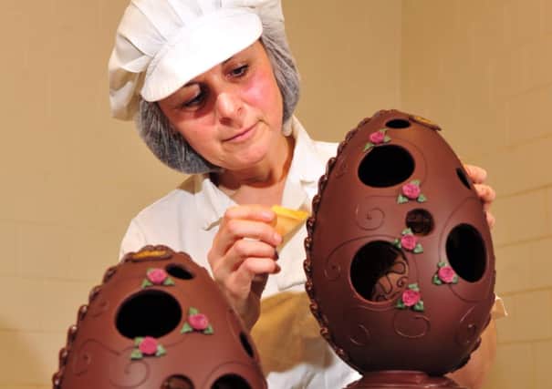 Betty's chocolatier Josie Raine adds the finishing gold shimmer to the stunning new egg