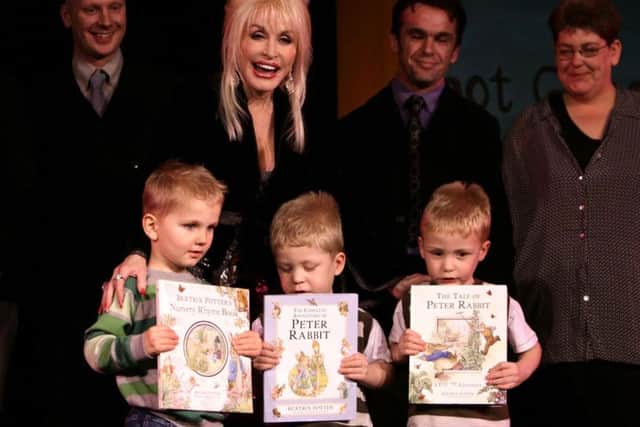 Dolly Parton, with children from Rotherham (left-right) Jack Boden, aged 3, and twins Jake and Josh Devey, aged 4, at the launch of her Imagination Library