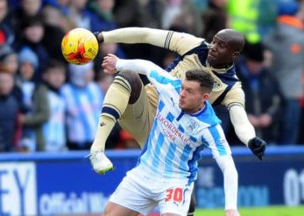 Leeds United's Sol Bamba battles with Huddersfield's Harry Bunn.