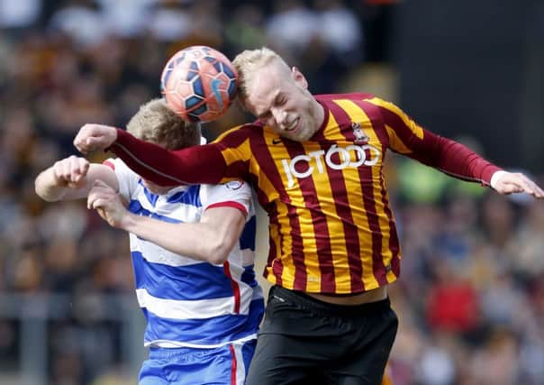 Reading's Pavel Pogrebnyak (left) and Bradford City's Andrew Davies battle for the ball in the air during the FA Cup Sixth Round match at Valley Parade