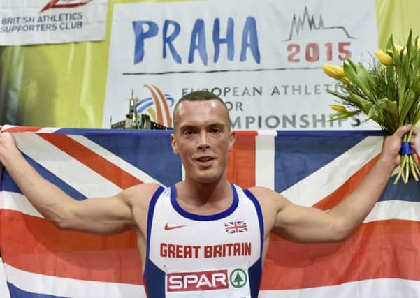 Britain's Richard Kilty  elebrates with the British flag after winning the gold medal in the men's 60m final at the European Athletics Indoor Championships in Prague, Czech Republic, Sunday. (AP Photo/Martin Meissner)