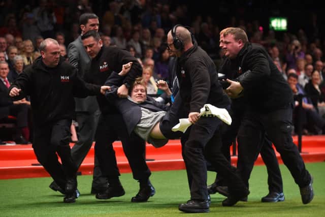 Protestor Luke Steele, a 25 year-old Leeds law student, was removed by security after entering the ring following the announcement of 'Best in Show' during day four of Crufts 2015 at the NEC in Birmingham. Picture by Joe Giddens/ PA Wire.