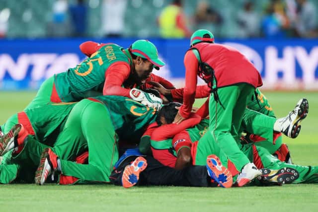 Bangladesh players celebrate after they defeated England by 15 runs in their Cricket World Cup Pool A match in Adelaide. (AP Photo/James Elsby)