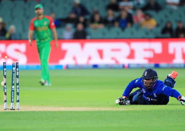 England batsman Chris Jordan watches as he is run out by Bangladesh Arafat Sunny, right. (AP Photo/James Elsby)
