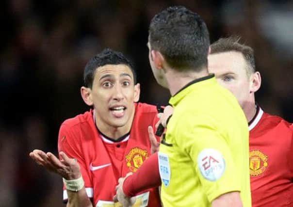 Manchester United's Angel Di Maria (left) protests to referee Michael Oliver before being sent off.