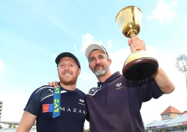 Yorkshire CCC head coach Jason Gillespie, right, celebrates winning the County Championship last season with captain Andrew Gale.