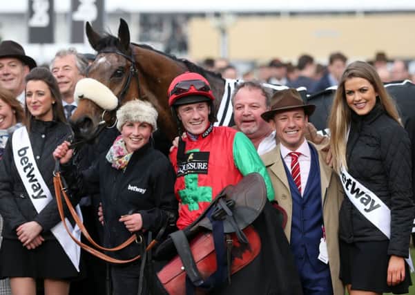 Jockey Sam Twiston-Davies celebrates with breeder Frankie Dettori (second right) after Dodging Bullets wins the Betway Queen Mother Champion Chase..