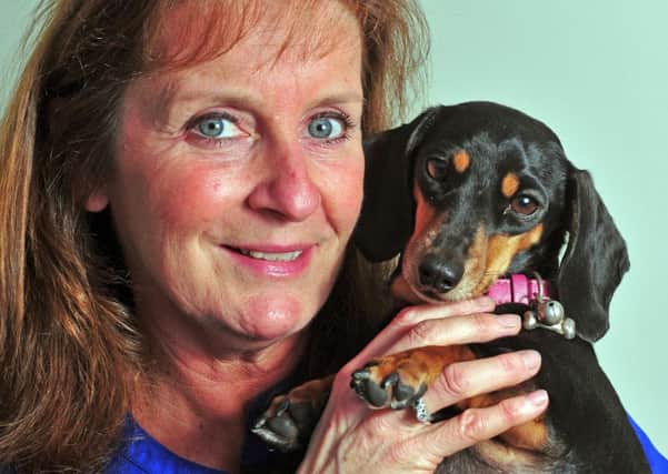 Nicola Linfield with miniature dachshund Lulu, now home safe and well. Picture by Tony Johnson