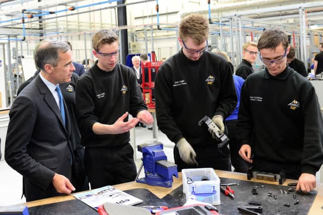 Mark Carney with apprentices at the  AMRC
