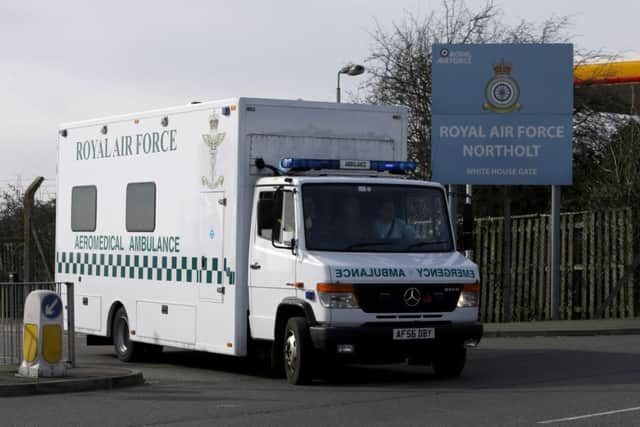 An RAF ambulance with a police escort convoy arrives, carrying a British military health care worker who has tested positive for the Ebola virus