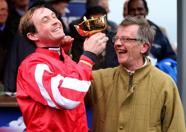 Jockey Nico de Boinville with the trophy and trainer Mark Bradstock after Coneygree wins the Betfred Cheltenham Gold Cup.