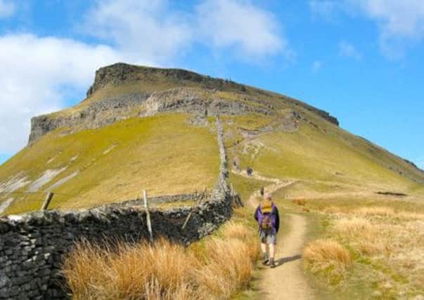 Pennine Way walkers on Penyghent. Footpath maintenace work will be hit by the spending cuts, says Carl Lis.