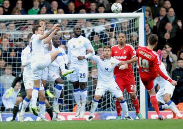 Leeds United players defend a Henri Lansbury free-kick.
