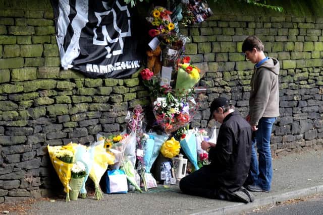 Flowers at scene where Grace Dyson (18) was walking with her fiancee, Jason Booth (20) along Springwood Rd in Thongsbridge, near Huddersfield, West Yorkshire. As he put up an umbrella the spike caught in the wall which caused them to stumble and she was knocked into the road and run over and killed by a passing van. See Ross Parry copy RPYUMBRELLA : 

rossparry.co.uk