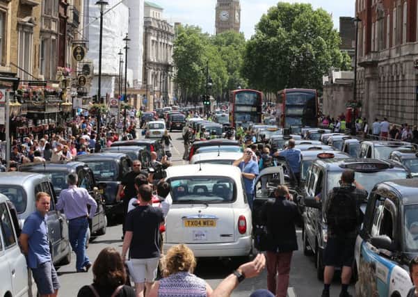 London cabbies protest at the impact of the Uber system on their business.