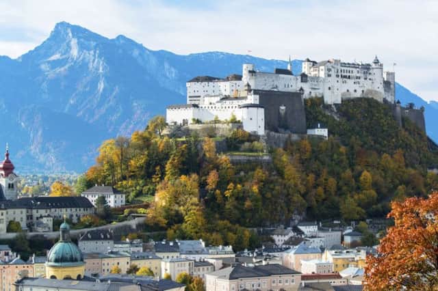 The majesty of the Alps towers over the cityscape of Salzburg