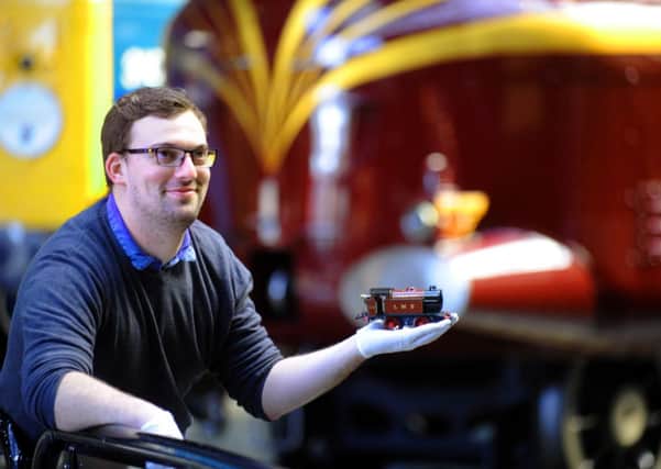 Playing Trains project manager Chris Walker holding a Hornby clockwork train