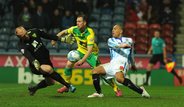 John Ruddy saves a point-blank shot from Huddersfield's James Vaughan.   Picture: Bruce Rollinson