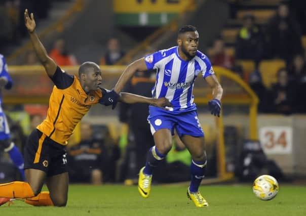 Sheffield Wednesday's Claude Dielna gets away from Wolves Benik Afobe at Molineux last night.