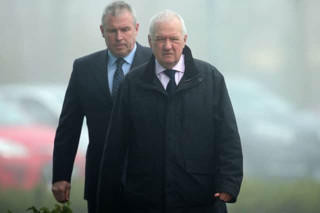 Former chief superintendent David Duckenfield (front) is escorted in to the Hillsborough Inquest in Warrington