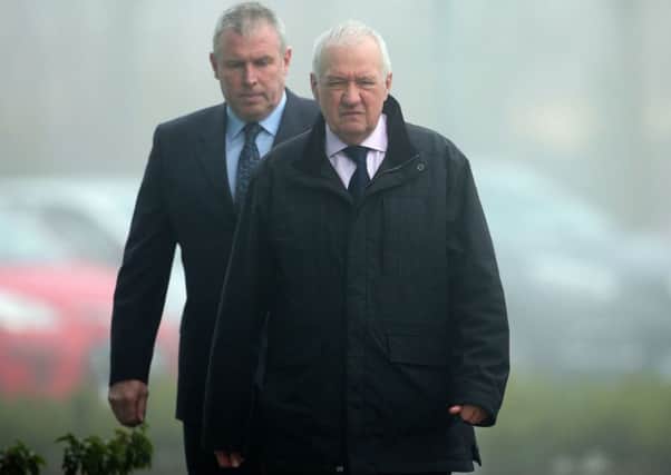 Former chief superintendent David Duckenfield (front) is escorted in to the Hillsborough Inquest in Warrington