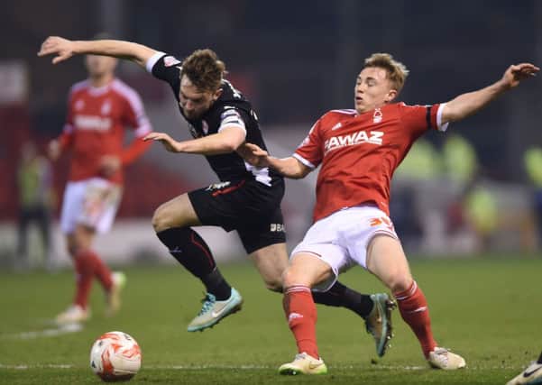 Rotherham United's Lee Frecklington, left, is fouled by Nottingham Forest's Ben Osborn, right, during the Championship match at the City Ground.