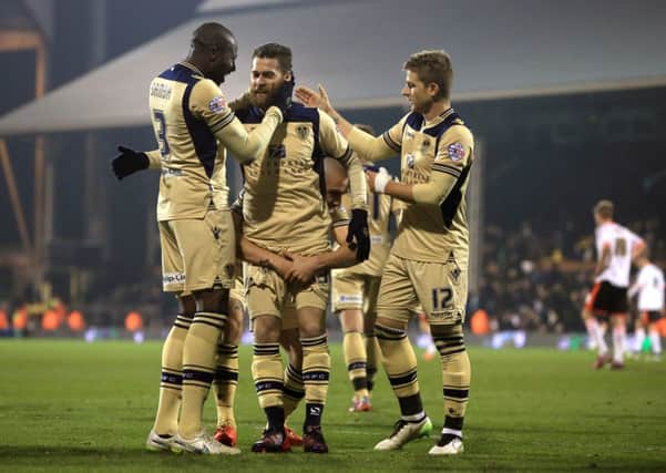 Leeds United's Mirco Antenucci (centre) celebrates scoring his sides third goal of the game with teammates  Souleymane Bamba, (left) and  Gaetano Berardi, (right)