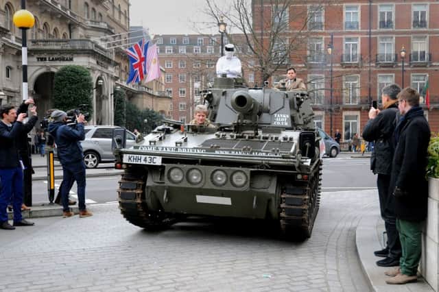 A man dressed as Top Gear's 'The Stig' delivers a million signature petition by tank to the BBC at the New Broadcasting House, London.