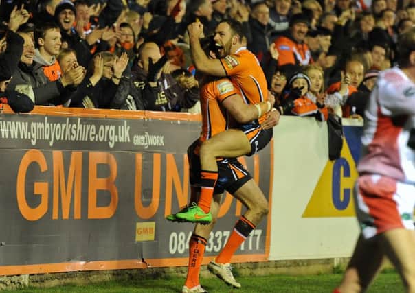 Michael Shenton celebrates a try with Luke Gale of Castleford Tigers.