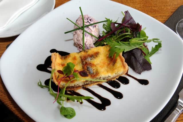A starter of Yorkshire Blue and caramelised red onion tart with red cabbage and celeriac coleslaw  at  The Sawley Arms, Sawley near Ripon.