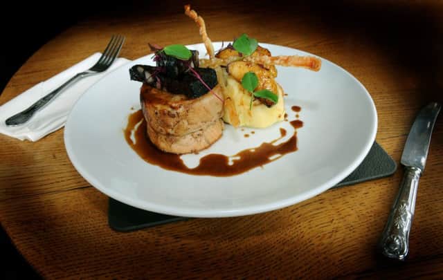 A main course of slow roast local pork belly with crispy crackling, apple mash, black pudding, cider and pork jus at The Sawley Arms, Sawley near Ripon.