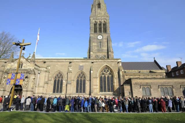 Members of the public queue outside Leicester Cathedral to view the coffin of Richard III in Leicester