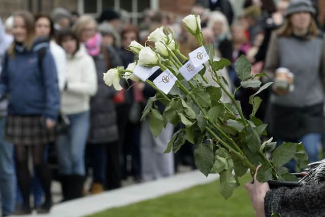 White roses are sold outside as people queue to view the coffin holding the remains of Richard III