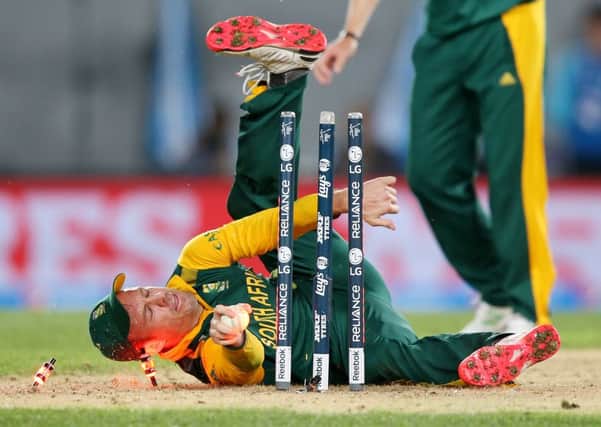 South Africa's AB de Villiers falls over as he attempts a run out during their Cricket World Cup semifinal against New Zealand in Auckland. (AP Photo/David Rowland)