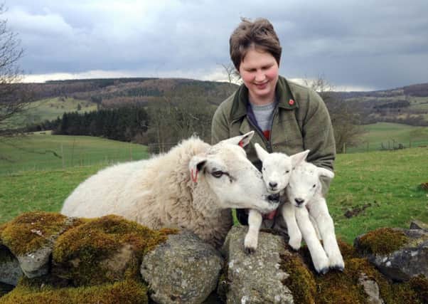 Sarah Wood's daughter Laura with spring lambs at Easterside Farm.