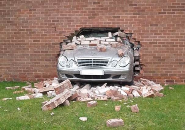A mechanic drove a gleaming Mercedes right through the back wall of the garage. Picture: Ross Parry Agency