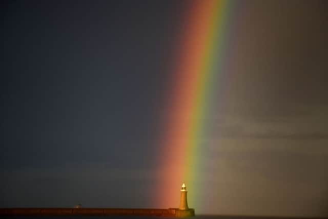 A rainbow appears over the lighthouse at Tynemouth