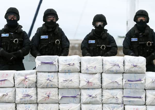 Members of the navy stand behind what is believed to be around 80 million euro (£62.5 million) worth of cocaine which was taken from onboard the yacht Makayabella