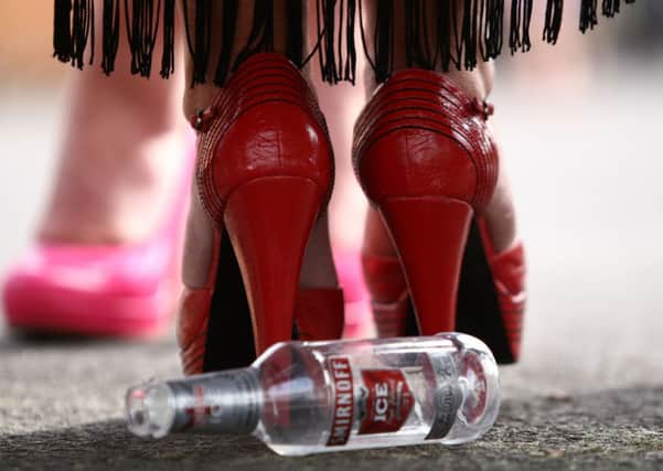 An empty bottle behind the shoes of a racegoer during Ladies Day at Aintree Racecourse, as bosses at the Grand National will aim to cover up the modesty of Liverpool ladies with a ban on unflattering photographs.
Photo: David Davies/PA Wire