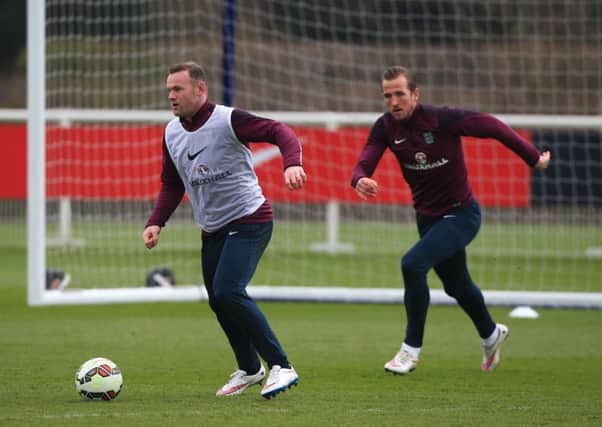 Wayne Rooney is trailed in training yesterday by Harry Kane, who could possibly partner him tonight for England (Picture:Nick Potts/PA Wire).