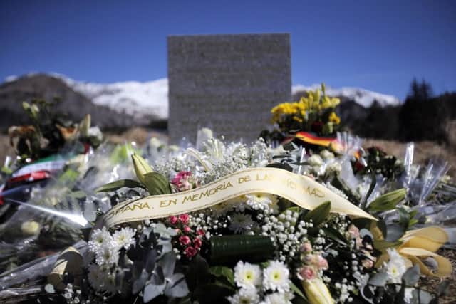 Flowers laid in memory of the victims are placed in the area where the Germanwings jetliner crashed in the French Alps
