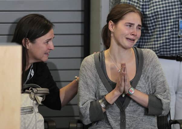 Amanda Knox, flanked by her mother Edda Mellas, at a news conference in Seattle, after returning home from Italy.