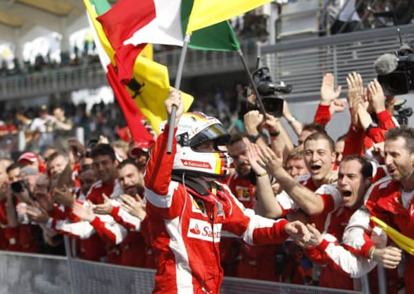 PRAINCING HORSE: Sebastian Vettel, foreground, delivered Ferraris first win for 35 grands prix with victory in Malaysia. Picture: Joshua Paul/AP.