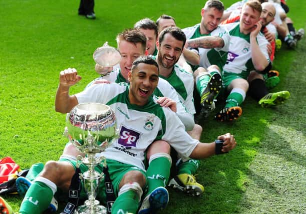 North Ferriby United players celebrate their 5-4 penalty shoot-out victory over Wrexham at Wembley with the FA Trophy. Picture:  Jonathan Gawthorpe.