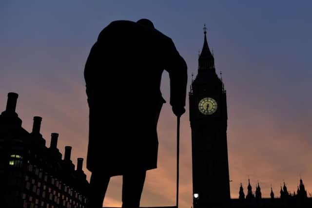 The sun rises behind the Palace of Westminster and the statue of Sir Winston Churchill, as one of the most closely-contested general elections for decades formally gets under way